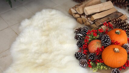 Thanksgiving decor features pinecones, red berries brighten cozy scene, pumpkins rest near soft rug, firewood adds warmth, pumpkins enhance autumn charm, cozy glow concept.