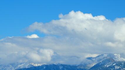 Snow Mountain With Opposite Direction Clouds. Clouds Running On Blue Sky Over Amazing White Landscape. Timelapse.