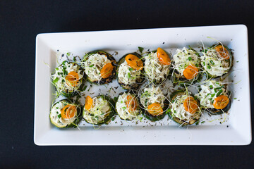 catering sushi rolls with zucchini, cheese and microgreens