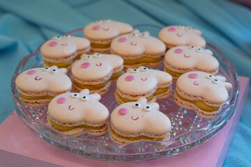 macaroons in the form of a pig on a glass plate.