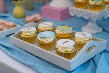 Cupcakes decorated with buttercream frosting on a buffet table