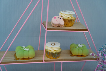 Cupcakes decorated with buttercream frosting on a buffet table