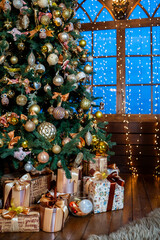Home New Year's interior. Christmas tree with gifts, decorated with garlands. Atmosphere of a home holiday, loft design of the room