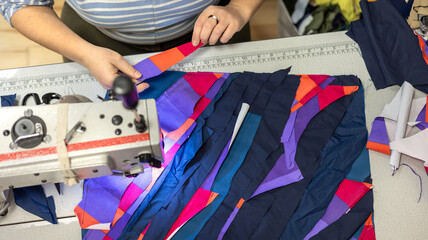 The process of sewing clothes from the remains of textiles and cut clothes. Upcycling, recycling, conscious consumption, zero waste. Youth clothing brand, sustainable fashion, reuse of materials.