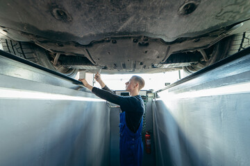 Auto mechanic adjustment automobile wheel alignment work at repair service station