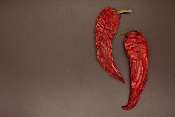 red hot chili pepper on dark brown background