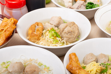 Bakso sapi, Various beef meatballs with accompaniments on wooden table. Most popular Indonesian foods
