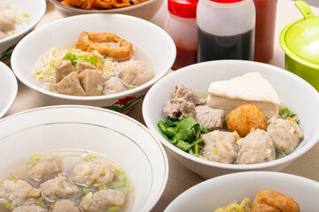 Bakso sapi, Various beef meatballs with accompaniments on wooden table. Most popular Indonesian foods