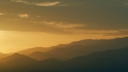 Beautiful Golden Sunrise. Silhouette Of The Mountain Hills Against Sunrise Sky. Real time.