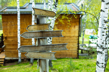 A wooden sign with four arrows pointing in different directions
