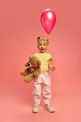 Full-length portrait of happy little girl, child with pink plaster on arm after vaccination,...