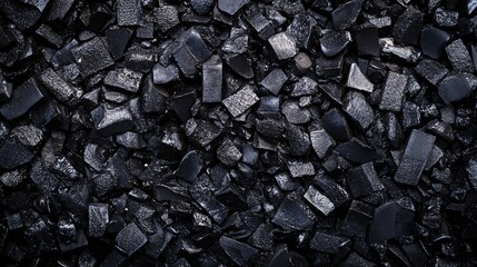 Black coal pieces forming a textured background for industrial concepts