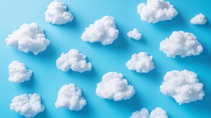Naklejka premium Soft, fluffy clouds scattered over a vibrant blue background, creating a serene and dreamy atmosphere.