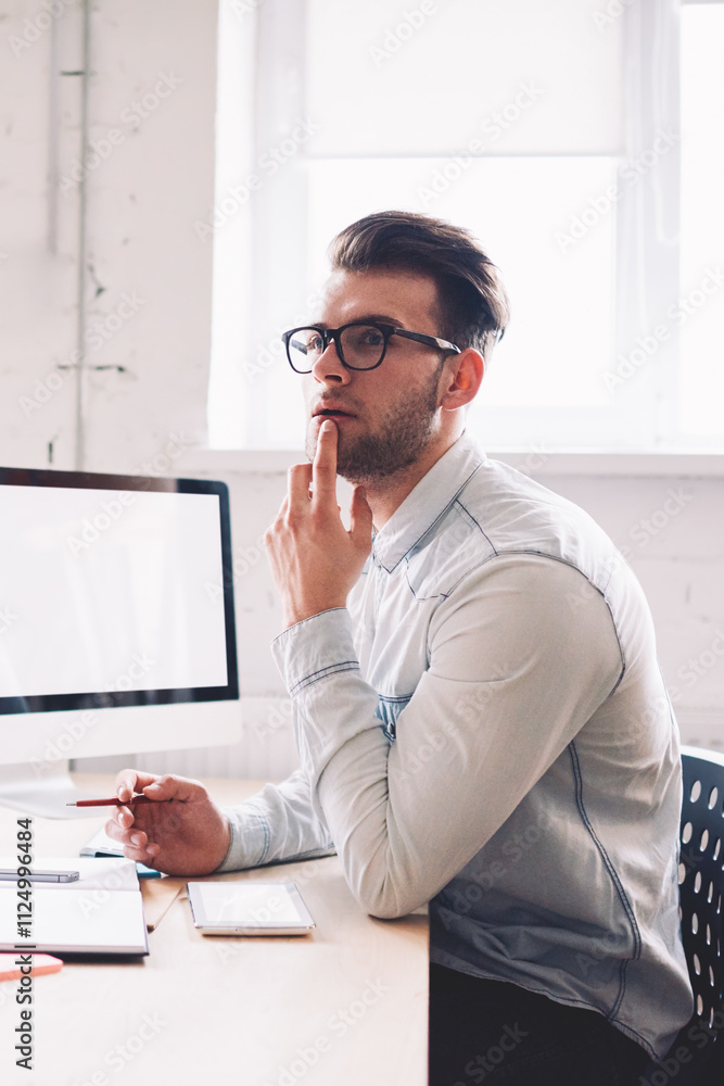 Poster caucasian serious male it developer pondering on false on website while sitting at desktop with comp
