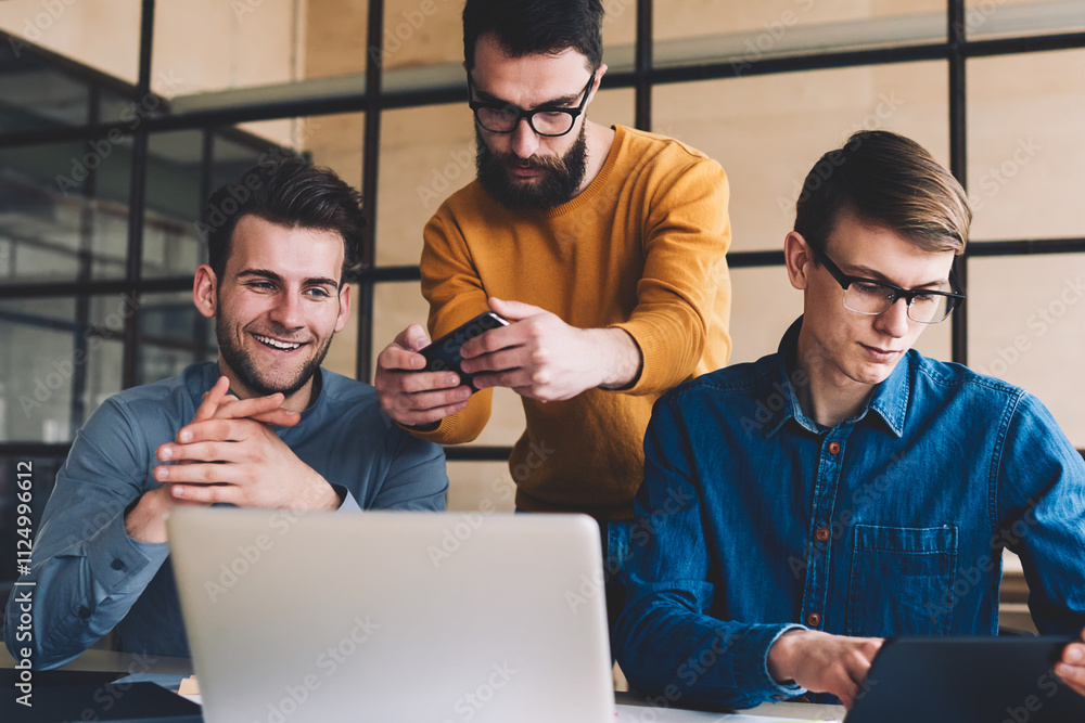 Aufkleber millennial hipster guys collaboration together in coworking space sitting at desktop with laptop whi