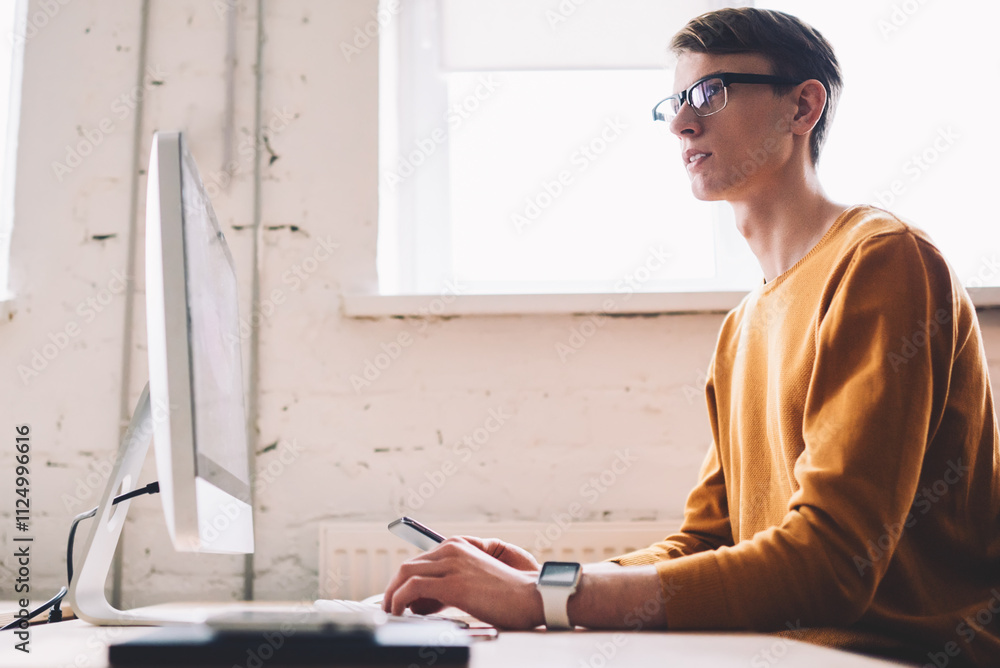 Poster thoughtful caucasian male it developer pondering on creating website sitting with modern computer on