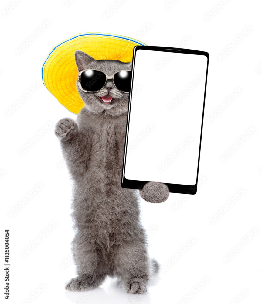 Poster Happy cat wearing sunglasses and summer hat standing on hind legs and showing big smartphone with white blank screen. Empty space for text. isolated on white background