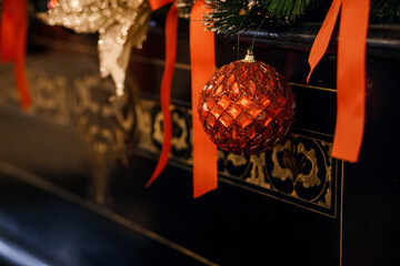 Glimmering Red Christmas Ornament on a Festive Mantelpiece Surrounded by Holiday Decor