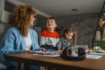 woman speech teacher with boy and girl on private lesson at home
