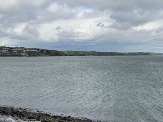 Lake and Beach Under a Cloudy Sky in the Highland Region