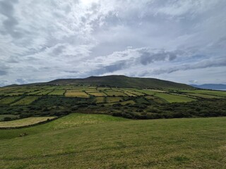 Fototapeta premium Mountain Landscape with Cloudy Sky and Greenery