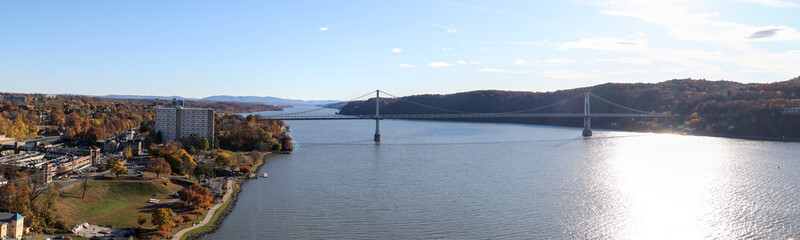 panoramic view of mid hudson bridge over hudson river valley (poughkeepsie, upstate new york) sunny day train station wide angle sun glare crossing suspension small town travel metro north