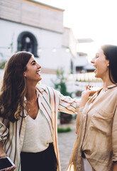 Excited toothy female fellows 20 years old satisfied with random meeting in city downtown, happy...