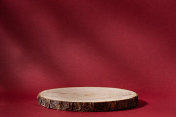 Wooden podium, product presentation stand on red background with copy space
