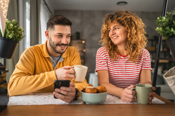 Happy couple have breakfast and cup of coffee at home morning routine