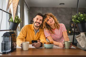 Happy couple have breakfast and cup of coffee at home morning routine