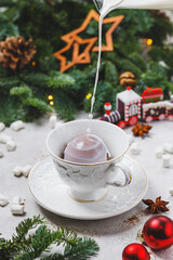 Milk is poured into a mug with a chocolate bomb. Dessert filled with hot milk.