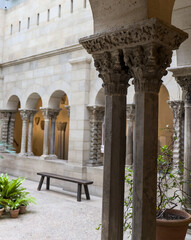 Naklejka premium scenic plants in arched garden sitting area (historic building) arch columns history european style architecture design garden courtyard