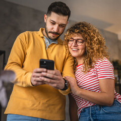 couple girlfriend and boyfriend have fun while use cellphone at home