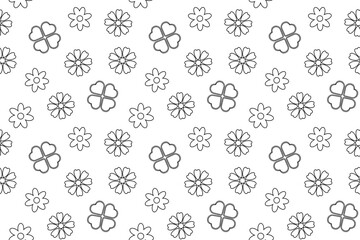 A seamless black and white pattern featuring flowers and four-leaf clovers, perfect for childrens coloring pages.