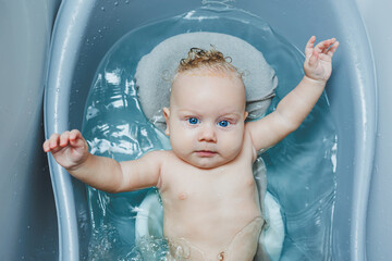 Bathing a baby at home in the bathroom. Personal hygiene of the baby. Care for the baby's skin.