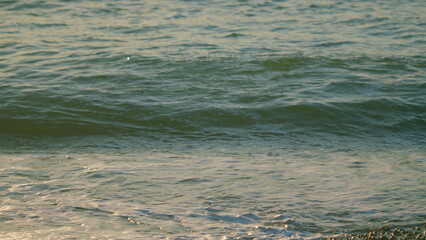 Sea Ripples. Sun Rays Is Reflected On The Sea Surface Of The Water. Ocean Shiny Sun Rays Glitter On The Water. Slow motion.