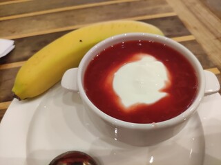 Ukrainian red soup borsch in a white plate