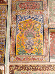 A vibrant flower mural in a decorative vase decorates a historical site, showcasing traditional craftsmanship