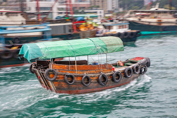 a junk water taxi in the Harbor of ABerdeen at the istalnd of Victoria in Hongkong