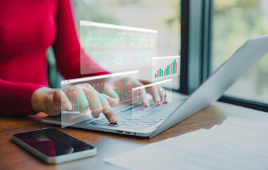 Professional women wearing red sweater working about new startup on laptop to analysis finance of...