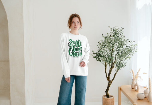 Mockup Of Woman Wearing Customized Sweatshirt By Wall