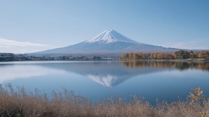 Realistic Mount Fuji in autumn, surrounded by golden foliage and a clear, reflective lake in the foreground.