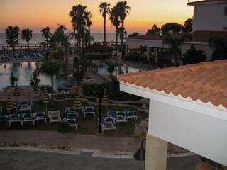 Fototapeta premium Sunset over pool at coastal resort