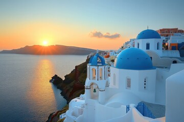 Obraz premium A serene sunset over Santorini with iconic blue-domed buildings by the sea.