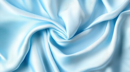 Obraz premium A smooth and luxurious blue fabric, artistically draped and folded, creating an elegant swirl and fluid appearance, capturing the essence of softness and elegance.