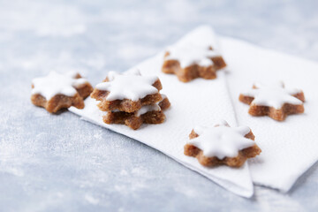 Christmas cookies (cinnamon stars) on bright background. Close up.