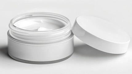 Moisturizing cream in a white container with a lid placed on a plain background