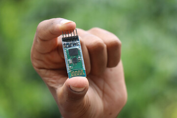 Bluetooth module used for wireless communication used in making robotics project held in the hand