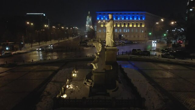 Monument of Cyril, Methodius and St Andrew the Apostle, in Kiev, Ukraina with city lights at night