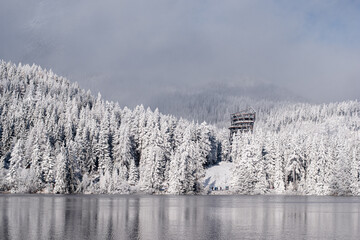 Obraz premium beautiful snowland scenery with hotel, lake and snowy trees in winter wonder fairytale